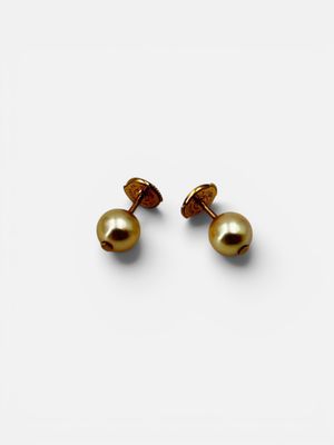 a pair of gold pearl earrings on a white background