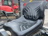 a black seat on a forklift in a parking lot