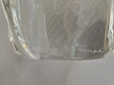 a glass jar with a liquid inside of it on a table