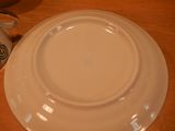 a white plate sitting on top of a wooden table