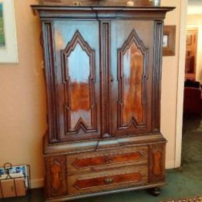 a large wooden cabinet in the middle of a living room