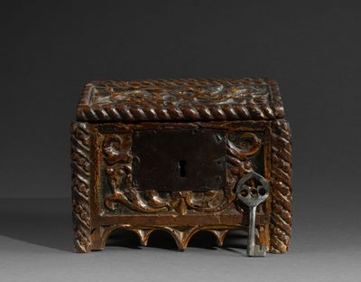 a small wooden box with a key in it