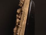 a sculpture of a man and woman on a wooden base