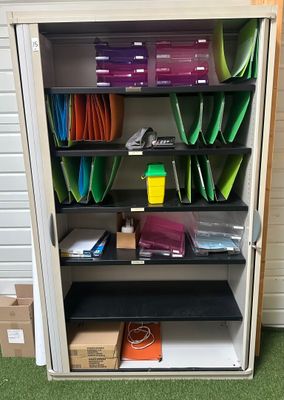 a metal cabinet with many files and folders on it