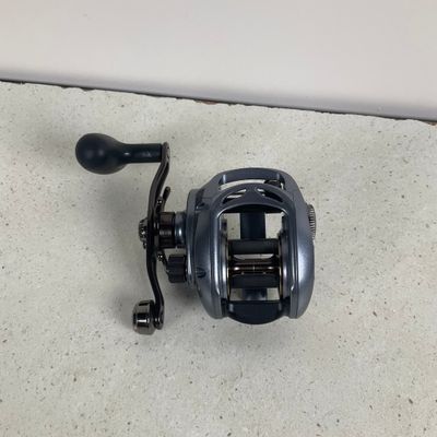 a close up of a fishing reel on the ground