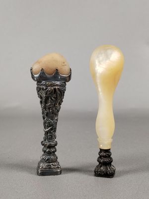two small vases with eggs in them sitting next to each other