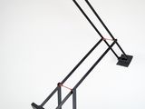 an image of a black desk lamp on a white surface