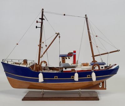 a model of a boat on a stand on a white surface
