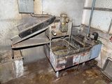 a dirty kitchen with a sink and a stove in it