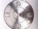a silver plate with a clock on it on a white surface