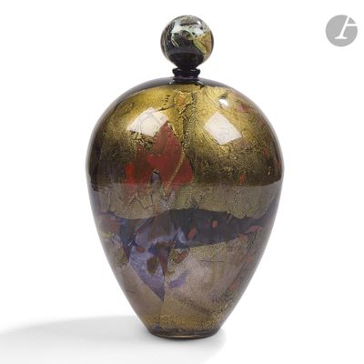 a vase with a lid that has a design on it