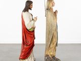 two statues of jesus and mary are standing next to each other