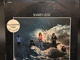 the album cover for shakey less, featuring a picture of a group of people on a wave