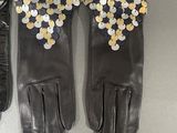 pair of black leather gloves with gold and silver sequins on them