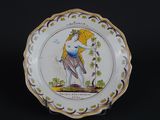 an image of a plate with a woman holding a bird on it
