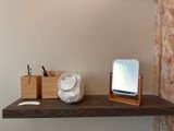 a wooden shelf with a mirror on top of it