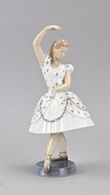 figurine of a ballerina in a white dress on a base