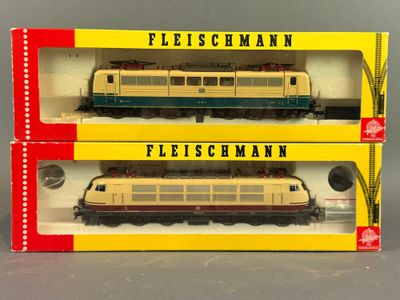 Deux trains en boîte sont posés côte à côte sur une table