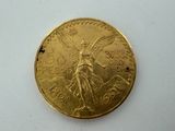 a close up of a gold coin on a white surface