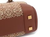 the brown and white bag is sitting on a white surface
