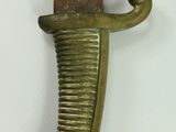 a knife hanging on a wall with a tag on it