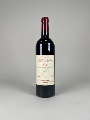 the bottle of red wine is sitting on the table