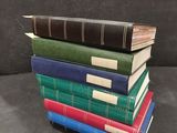 several books stacked on top of each other on a table