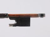 an old violin bow with a wooden handle on a white background