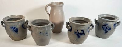 four vases sitting next to each other on a table
