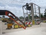 a crane that is sitting in the middle of a parking lot