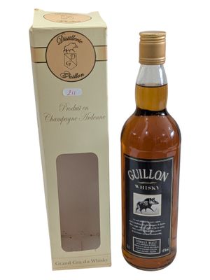 an image of a bottle of whisky next to a cardboard box
