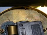 a close up of a metal object with a button on it