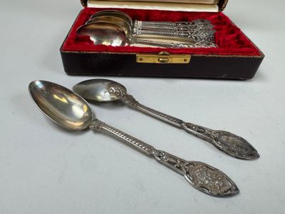 two spoons and a spoon rest in a case