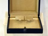 a close up of a box with a watch inside of it