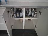 a white cabinet with a lot of bottles on top of it