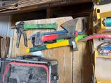 many different tools hanging on the wall in this garage