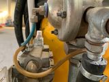 a close up of a fire hydrant with a hose attached to it