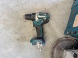 a drill and a circular saw on the floor