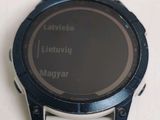 a close up of a smart watch on a white surface