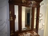 a mirror on a wooden cabinet in a room