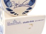 a blue and white vase sitting on top of a white box