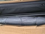 a black bag that is sitting inside of a cardboard box