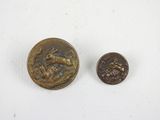 an old coin and a small bronze coin on a white surface