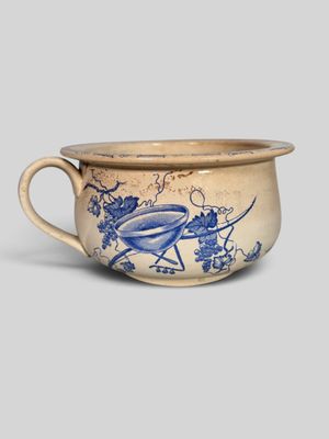 an old blue and white cup with a bird on it