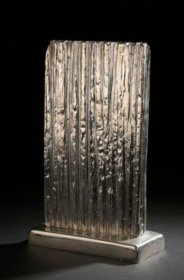 a close up of a glass sculpture on a stand on a table