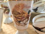 a white vase with a picture of a cat on it