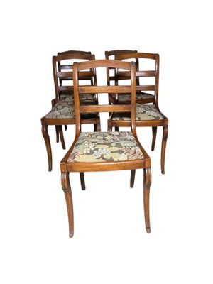 four wooden chairs with upholstered seats and a floral seat pad