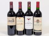 three bottles of red wine are lined up on a white surface