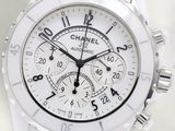 a close up of a watch with a white face