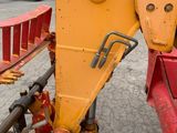 an image of a fork attachment attached to the back of a tractor